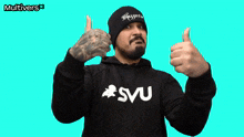 a man giving a thumbs up wearing a shirt that says svu