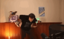 a man in a black shirt is holding a sign that says ' twitch ' on it