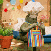 a stuffed animal wearing a chef 's hat and apron