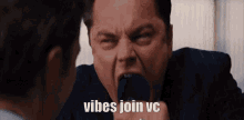 a man in a suit is screaming into a microphone with the words vibes join vc written below him