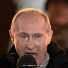 a close up of a man speaking into a microphone with the words yes to great russia below him