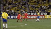 a soccer game is being played in front of a mcdonald 's advertisement