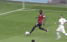 a soccer game is being played on a field with an advertisement for lux ant in the background