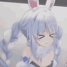 a girl with white hair and bunny ears makes a funny face