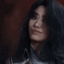 a close up of a woman 's face with long black hair