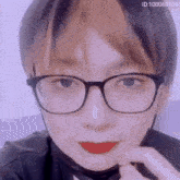 a close up of a person 's face with glasses and red lipstick
