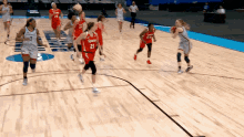 a basketball game is being played on a court that has syracuse written on the floor