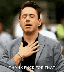 a man in a suit holds his hand to his chest with the words thank fuck for that written below him