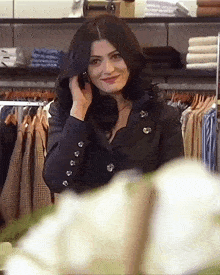 a woman is talking on a cell phone in a store