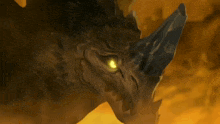 a close up of a dragon 's face with a yellow eye