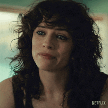 a close up of a woman 's face with the netflix logo visible