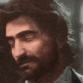 a close up of a man 's face with his eyes closed .