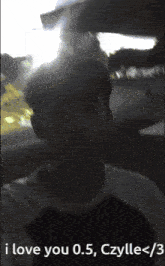 a man taking a selfie with the words i love you 0.5 dzylle < 3 below him