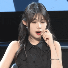a woman wearing a black shirt and a bracelet that says ' good ' on it