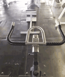 a person is riding an exercise bike in a gym with the number 01606 on the floor