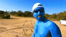 a shirtless man with blue paint on his face