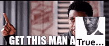 a man is pointing at a picture of a man with the words `` get this man a true ... ''
