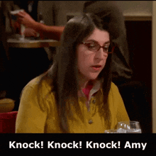 a woman wearing glasses is sitting at a table with the words knock knock knock amy above her