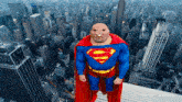 a man in a superman costume stands in front of a cityscape