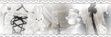 a black and white photo of a stuffed bunny and a cup