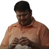 a man with a beard wearing an orange shirt is holding a piece of paper