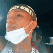 a man wearing a mask and a headband with the word zoi written on it