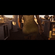 a woman in a white dress is standing in front of a bar