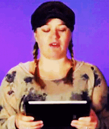 a woman with pigtails is holding a tablet