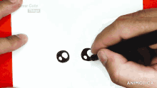 a person is drawing a pair of ear buds on a piece of paper ..