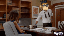 a gif of a woman sitting at a desk with a man wearing a monkey mask behind her
