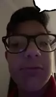 a close up of a person wearing glasses making a face