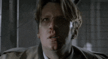 a close up of a man 's face with blood coming out of it