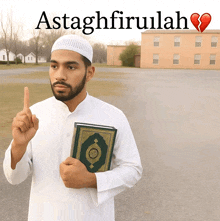a man holds a book in front of a sign that says astaghfirullah