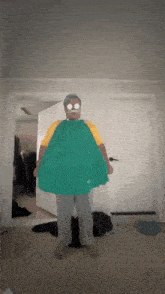 a man wearing a green cape and a yellow shirt