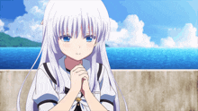a girl with white hair and blue eyes is standing in front of a body of water