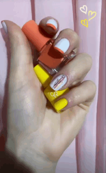 a woman holds three bottles of gr nail polish on her nails
