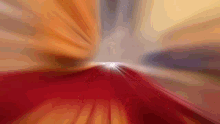 a blurred image of a red and orange background with a white light in the middle
