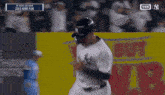 trent grisham runs to first base during a baseball game