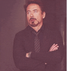 a man with a beard wearing a suit and tie
