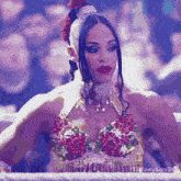 a woman in a floral bra is sitting in a boxing ring with the hashtag tiffanyluv24 on the bottom