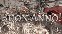 a person is pouring champagne into a pyramid of champagne flutes .