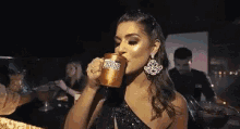a woman is drinking from a mug that says pink club on it