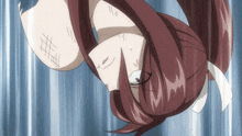 a girl with red hair is hanging upside down with a white ribbon around her neck