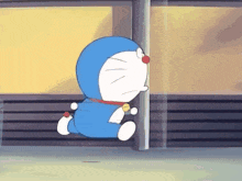 a blue and white cartoon character named doraemon is standing next to a pole