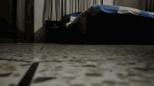 a person laying on a bed with a blue and white blanket