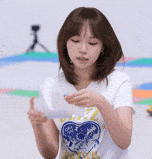 a woman wearing a shirt that says since 2007 is holding a piece of paper