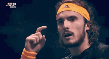 a man wearing a headband that says adidas