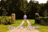 a man is running down a dirt road with the words on my way written on it