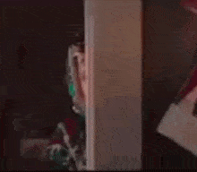 a blurry picture of a person in a red shirt standing in a room