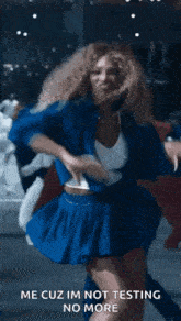 a woman in a blue skirt is dancing with a caption that says me cuz im not testing no more